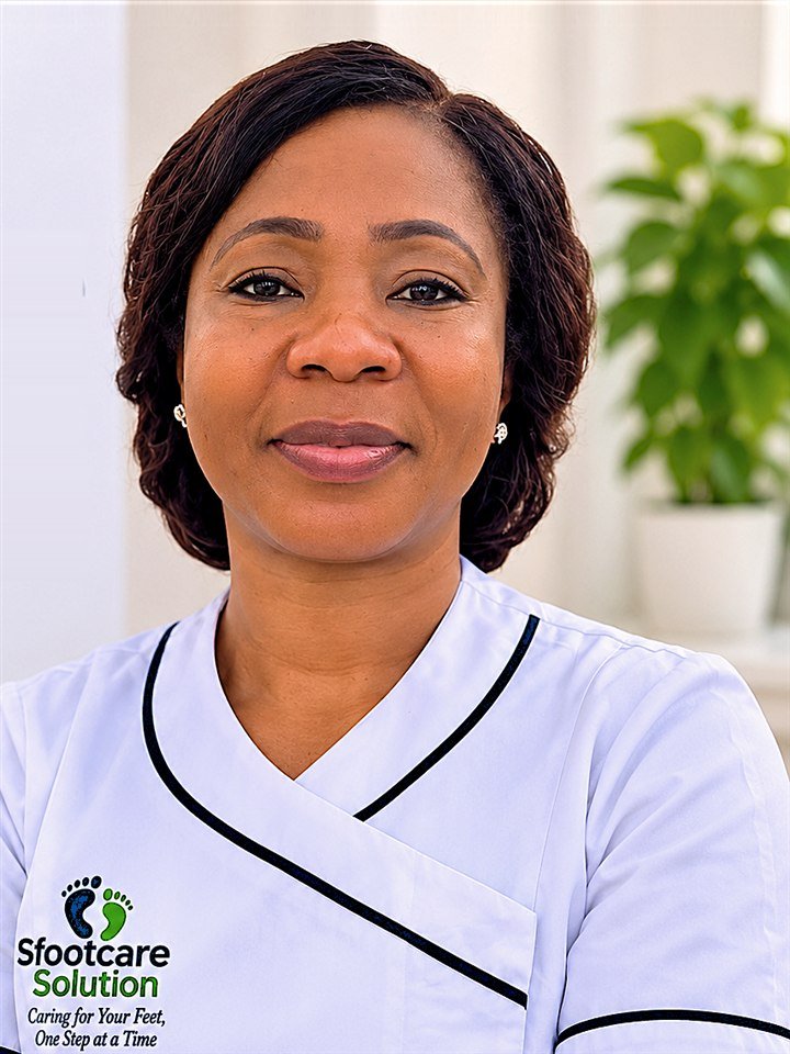 Oben smiling in her white Sfootcare Solution uniform